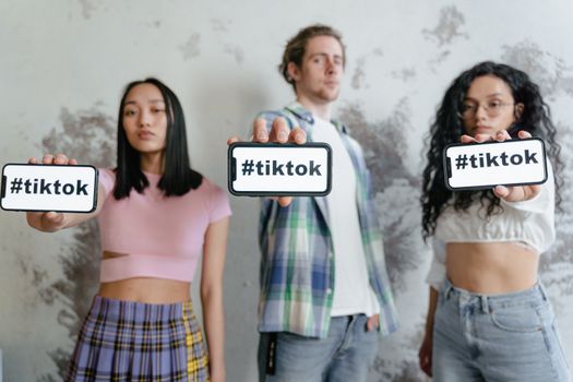 Jongvolwassene scrollt op TikTok op een smartphone terwijl festival- en foodcontent in beeld verschijnt